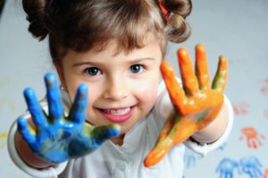 Handedness in Child Development. Dominant hand - left or right? - Little girl playing with colors